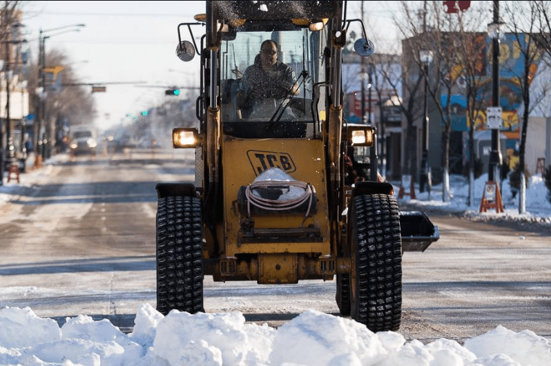 clearing the snow in the street